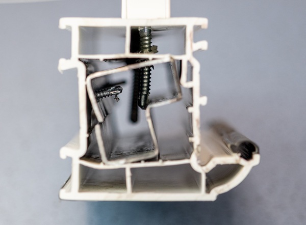 Section view of reinforced profile with miss-aligned retaining and handle attachment screws.